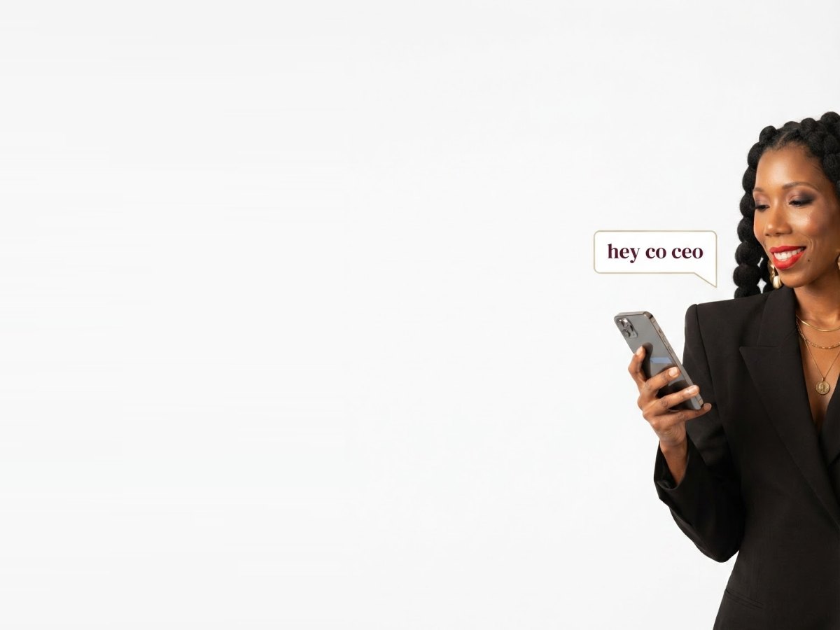 Danielle Lindsey looking at her phone beside a hey co-CEO message